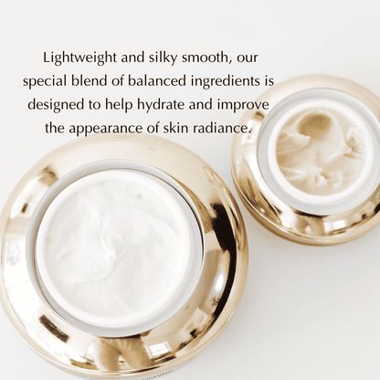 Gold-trim under-eye cream jars with swirled white cream and open lid