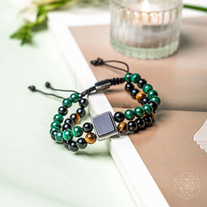 Beaded bracelet with black, green and amber beads and silver square clasp