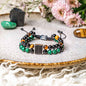 Beaded power bracelet with black, green and amber beads and a silver square charm