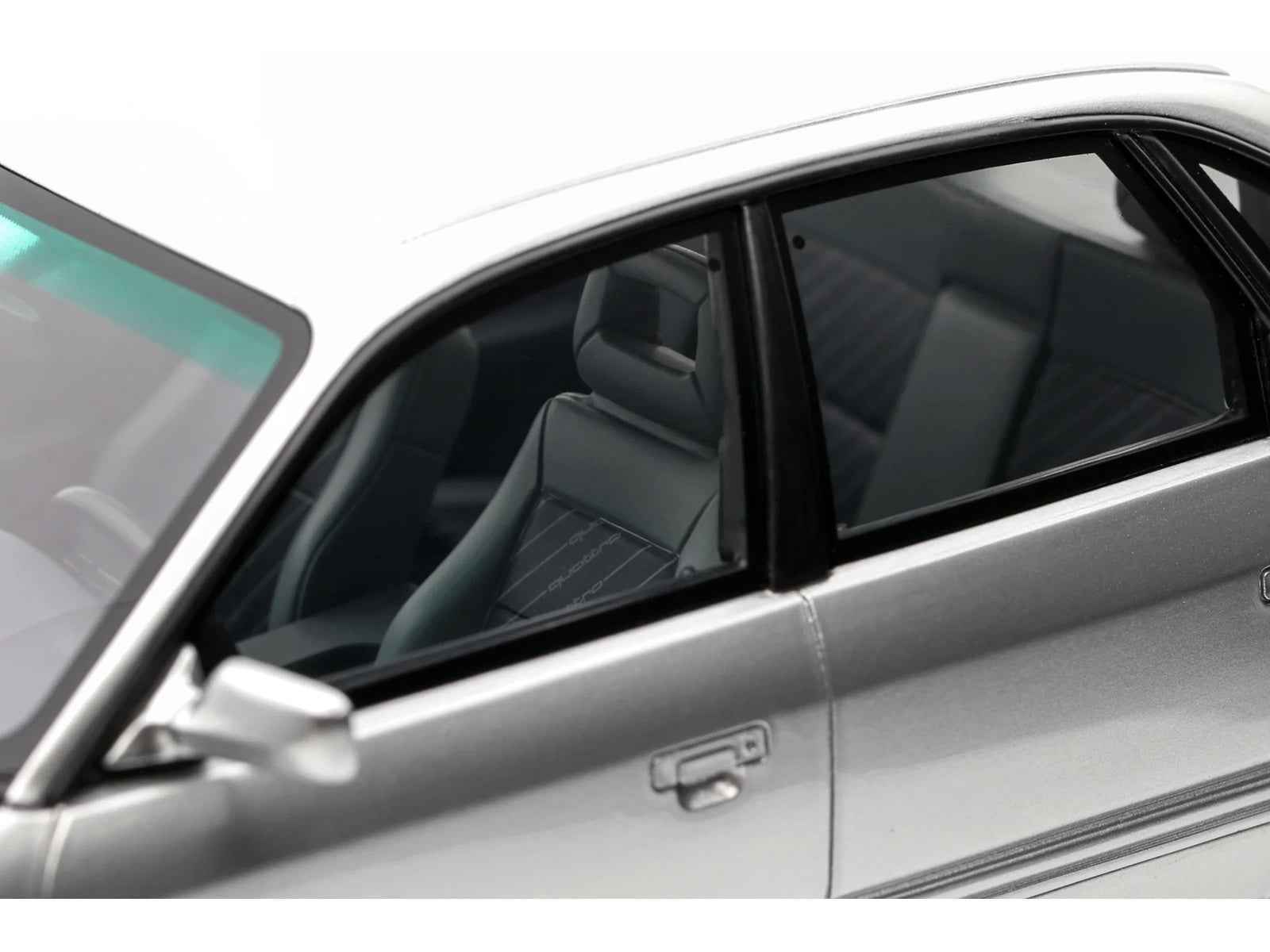 Silver Audi S4 model car door and front seats through side window