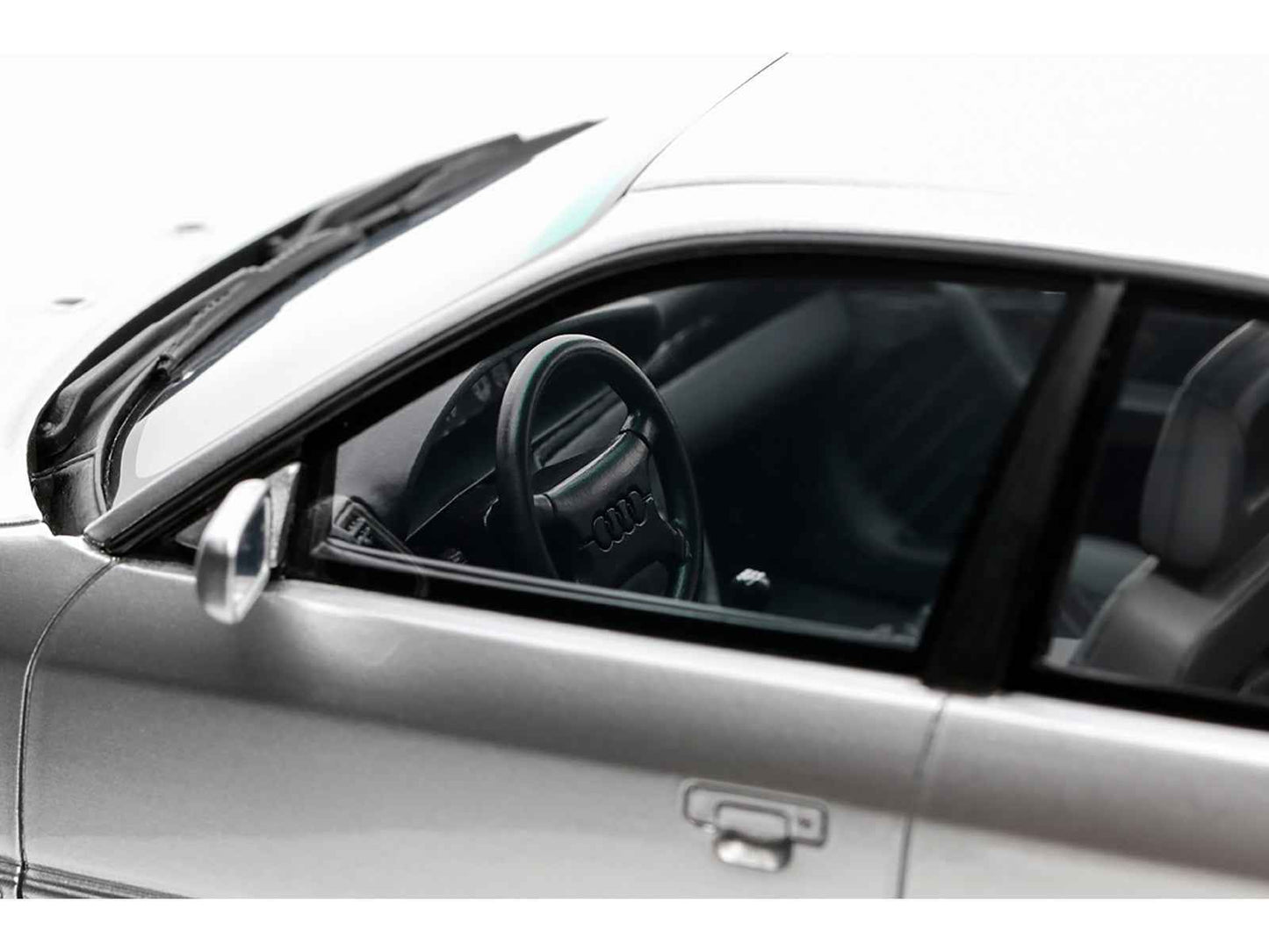 Silver Audi S4 model car interior view with black steering wheel