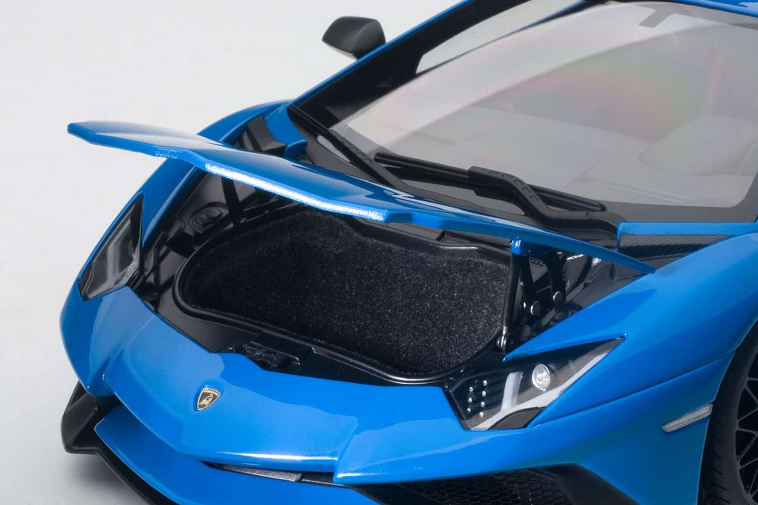 Blue sports car model with open engine bay and black hood detail