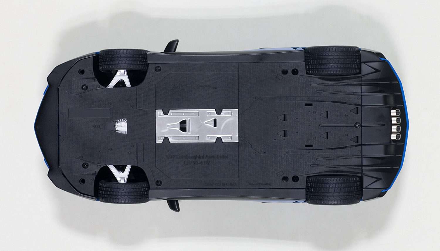 Blue 1:18 scale die-cast sports car, underside view with chassis details