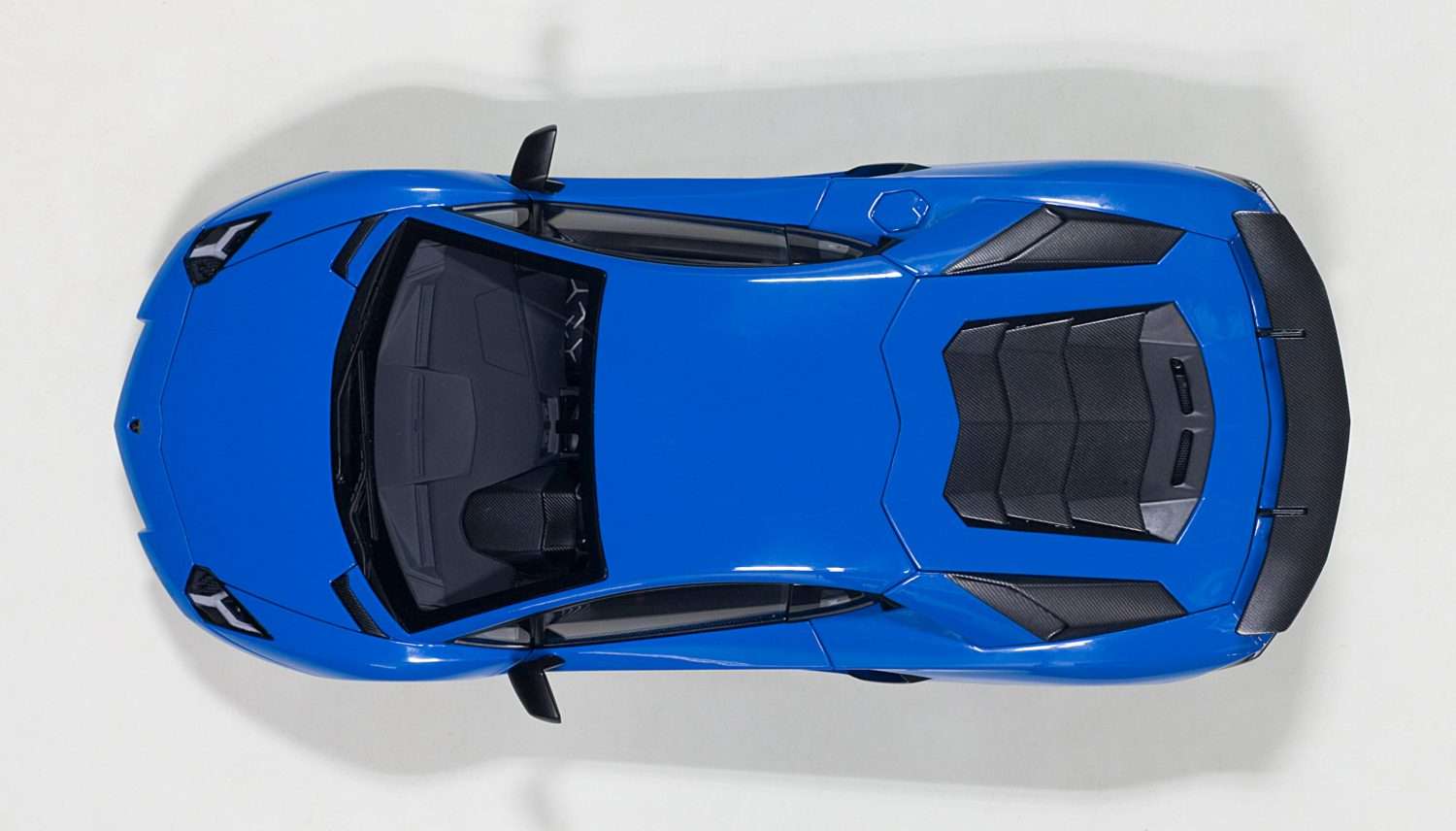 Blue 1:18 scale die-cast sports car, top-down view with roof vents