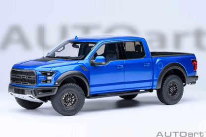 Blue pickup truck model with black grille, front bumper, and off-road tires, angled view