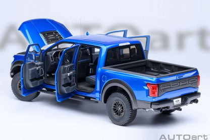 Blue pickup truck model with both doors open, showing dark seats and dashboard detail