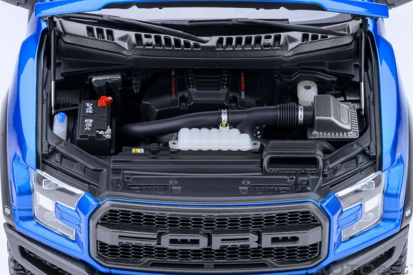 1:18 scale blue pickup truck front with open hood showing grille and engine