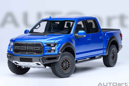 Blue pickup truck model with detailed front grille, headlights, and black wheels, angled view