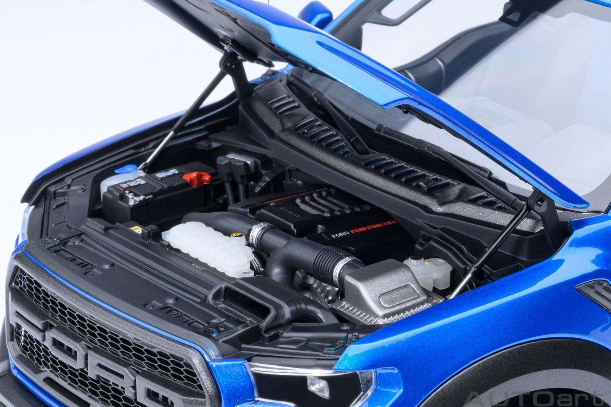1:18 scale blue pickup truck engine bay with detailed black components