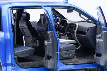 Blue pickup truck model interior with rear seats, dashboard, and open door frame