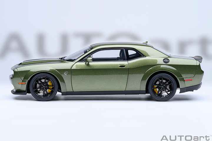 Green 1:18 scale Dodge Challenger model car side profile with black rims.