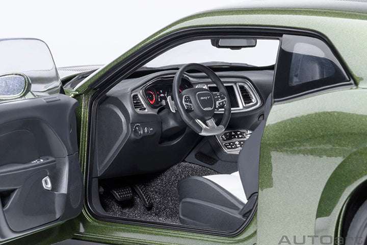 Interior view of a green 1:18 scale Dodge Challenger model car with black seats.