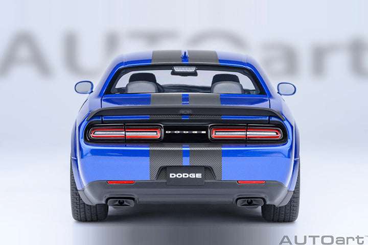 Rear view die-cast sports car model in indigo blue with red taillights and “DODGE” badge