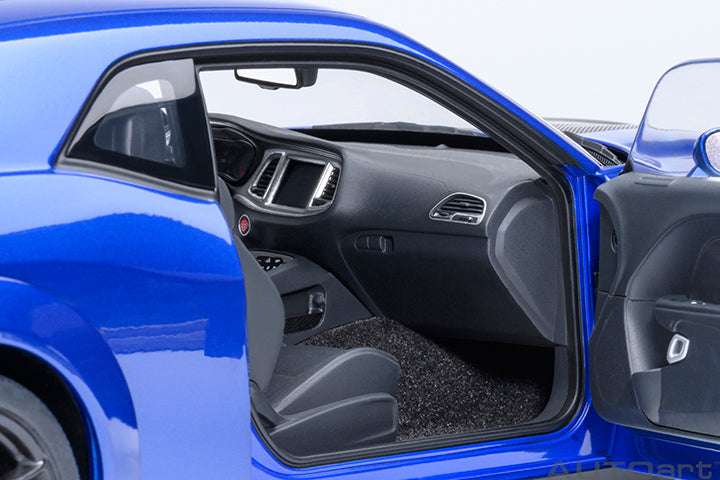 Passenger-side interior view of indigo blue die-cast sports car model with black seats