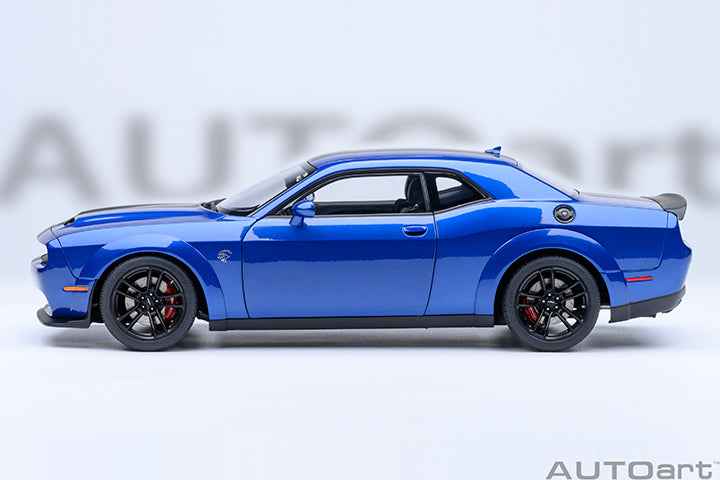 Indigo blue side-profile die-cast sports car model with black wheels and fender vents