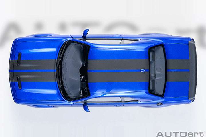 Top-down die-cast sports car model in indigo blue with black hood stripes and twin mirrors