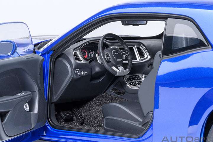Interior view of indigo blue die-cast sports car model with black dashboard and steering wheel