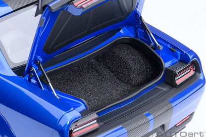 Blue die-cast sports car trunk area open, showing dark carpet lining and rear details.