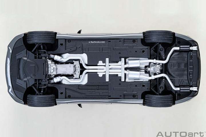 Underside of grey Dodge Charger widebody die-cast model car, exposed chassis components.