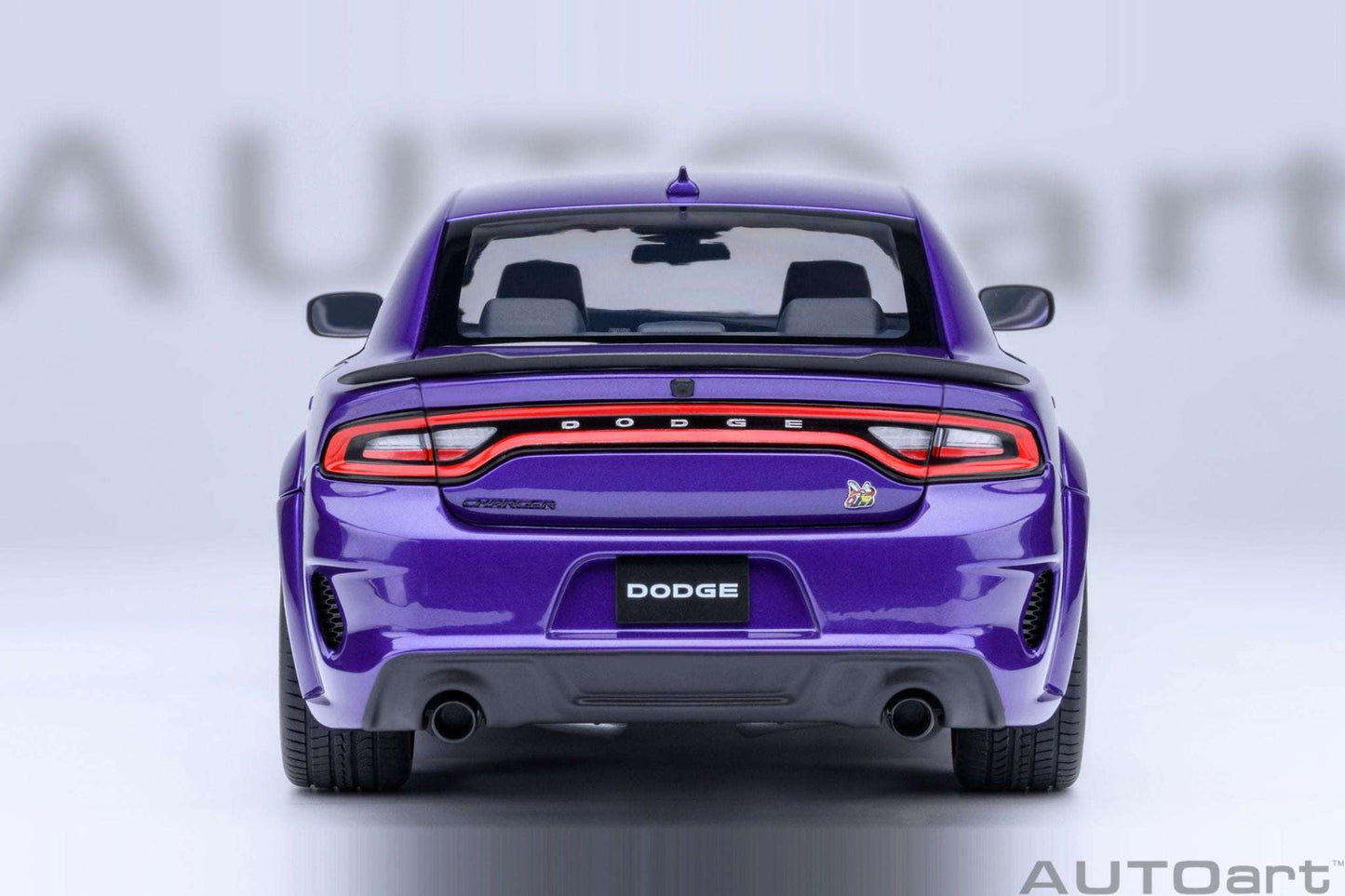AUTOart 1:18 scale purple Dodge Charger model, rear view with taillights and exhaust