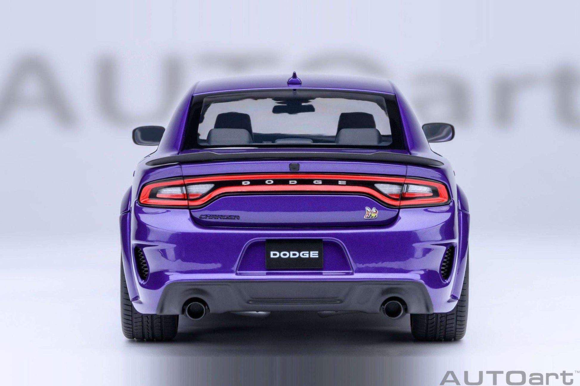 AUTOart 1:18 scale purple Dodge Charger model, rear view with taillights and exhaust