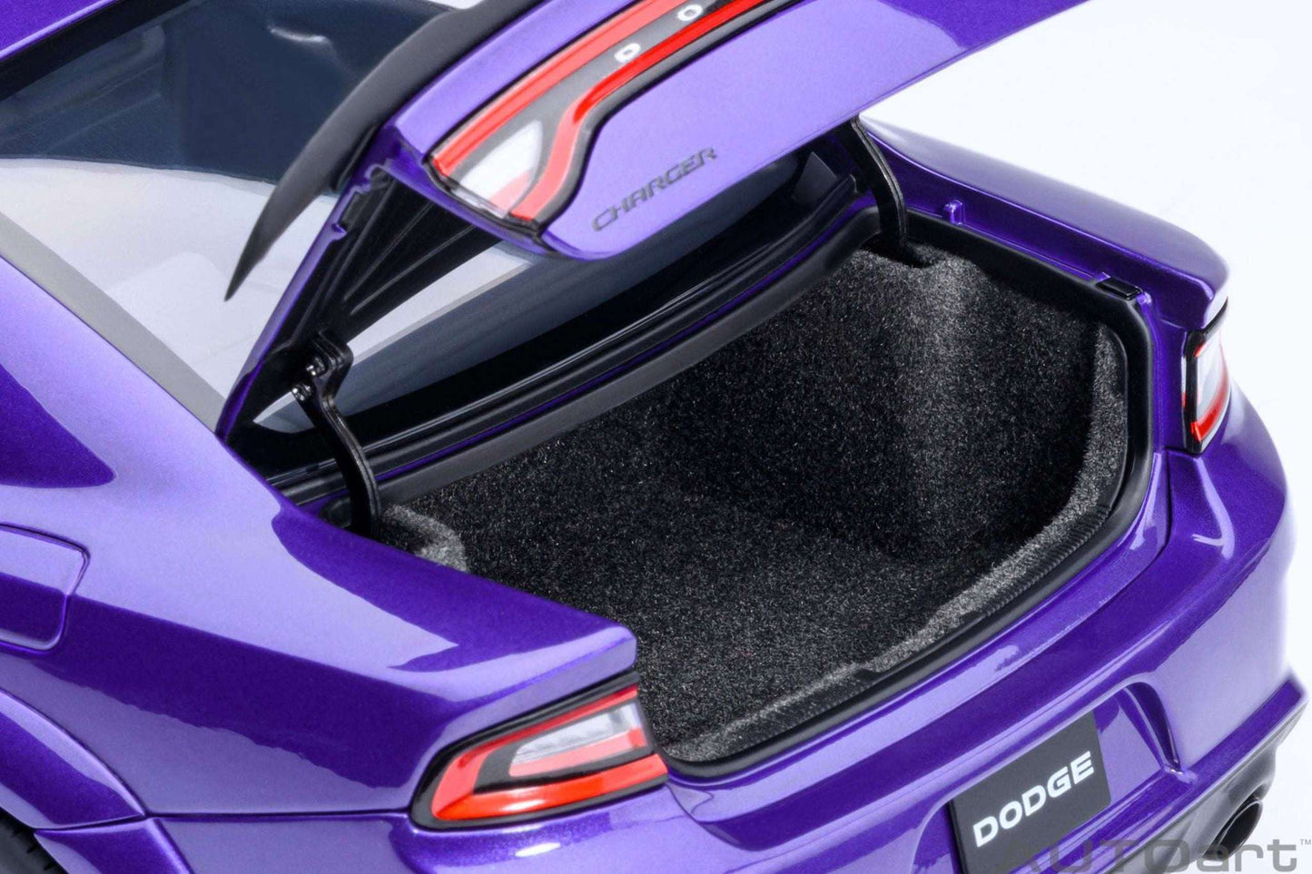 Purple die-cast muscle car trunk open with black carpet and rear taillight details