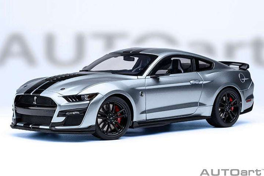 Metallic silver sports car model with front grille, hood stripes, and black wheels
