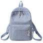 Light blue backpack with tassel drawstring, front zip pocket, and adjustable shoulder straps