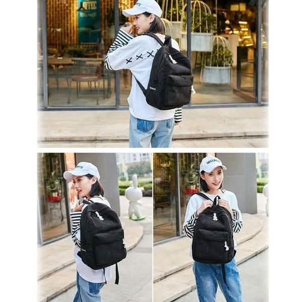 Black mini backpack with front zipper pocket and adjustable shoulder straps