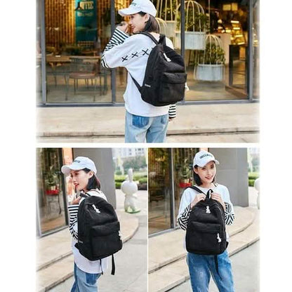 Black mini backpack with front zipper pocket and adjustable shoulder straps