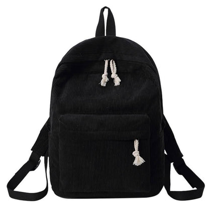 Black backpack with tassel drawstring, front zip pocket, and adjustable shoulder straps