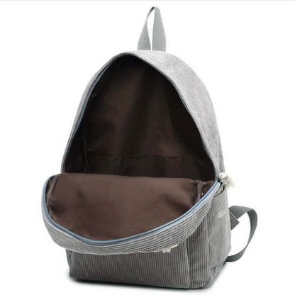 Light gray mini backpack with open top and adjustable shoulder straps, dark interior