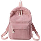 Pink backpack with tassel drawstring, front zip pocket, and adjustable shoulder straps