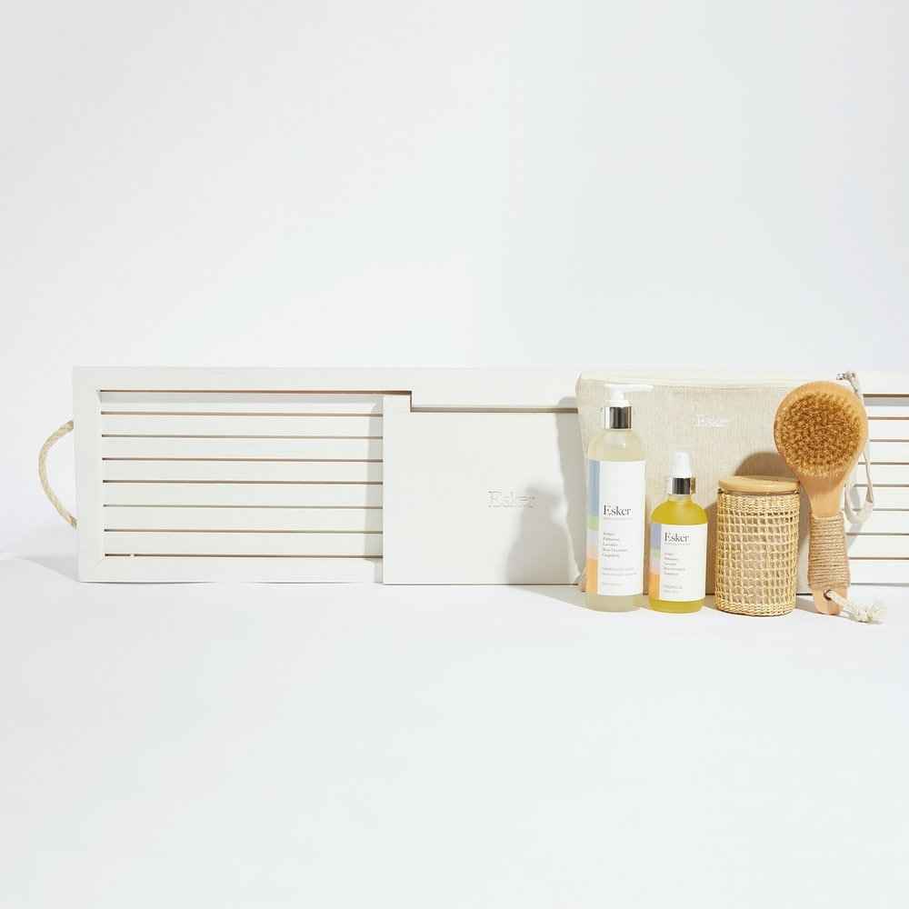 White wooden bath board with hinged design and slatted interior compartment