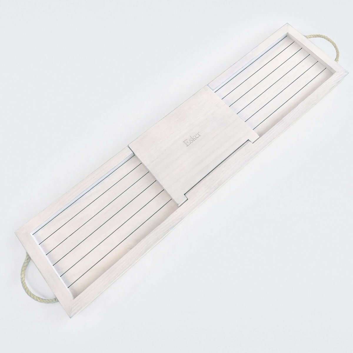 Bath board lying flat with white slatted sections, wooden center panel, and hanging loop.