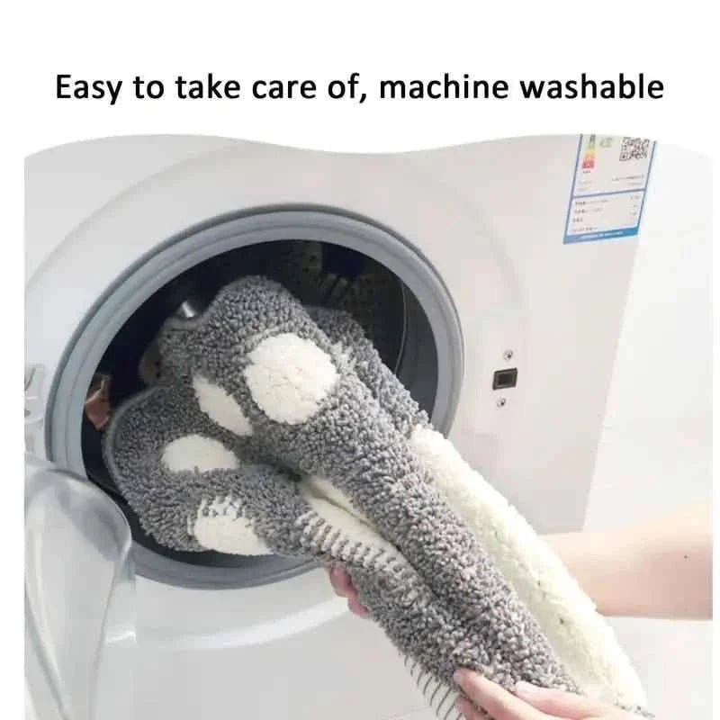 Gray paw-print bathroom rug mat with white pads, in a washing machine