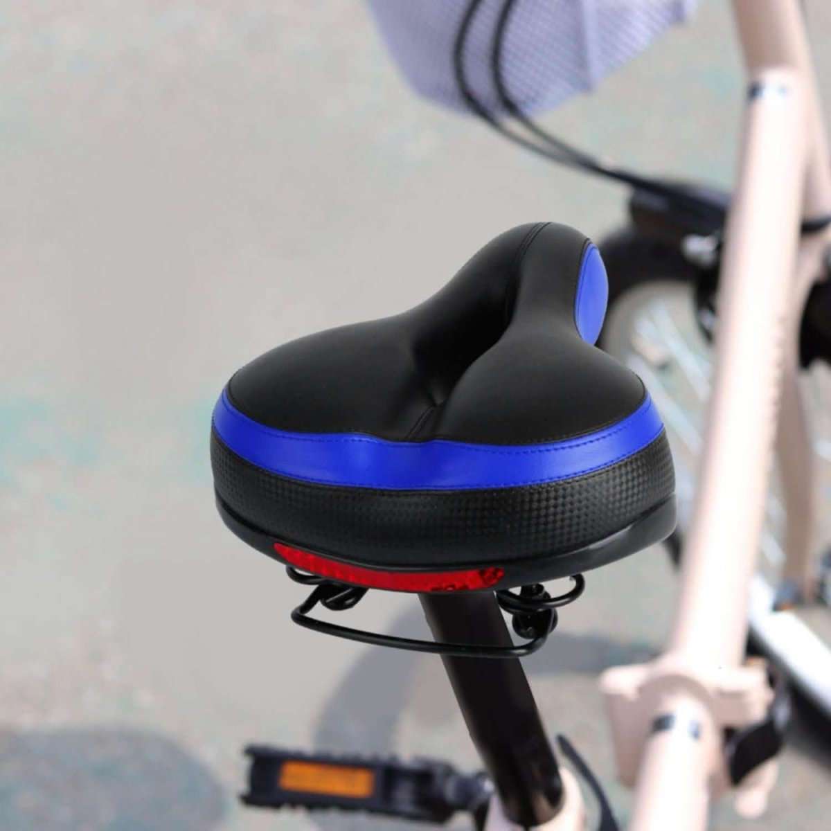 Black padded bike saddle with blue side panel detail on a bicycle