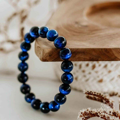 Beaded bracelet with dark blue and black round beads, elastic loop style