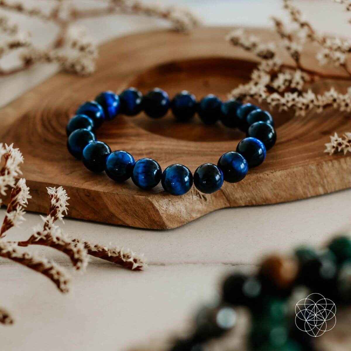 Dark blue beaded bracelet with glossy round beads arranged in a single strand