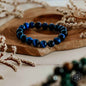 Dark blue beaded bracelet with glossy round beads arranged in a single strand