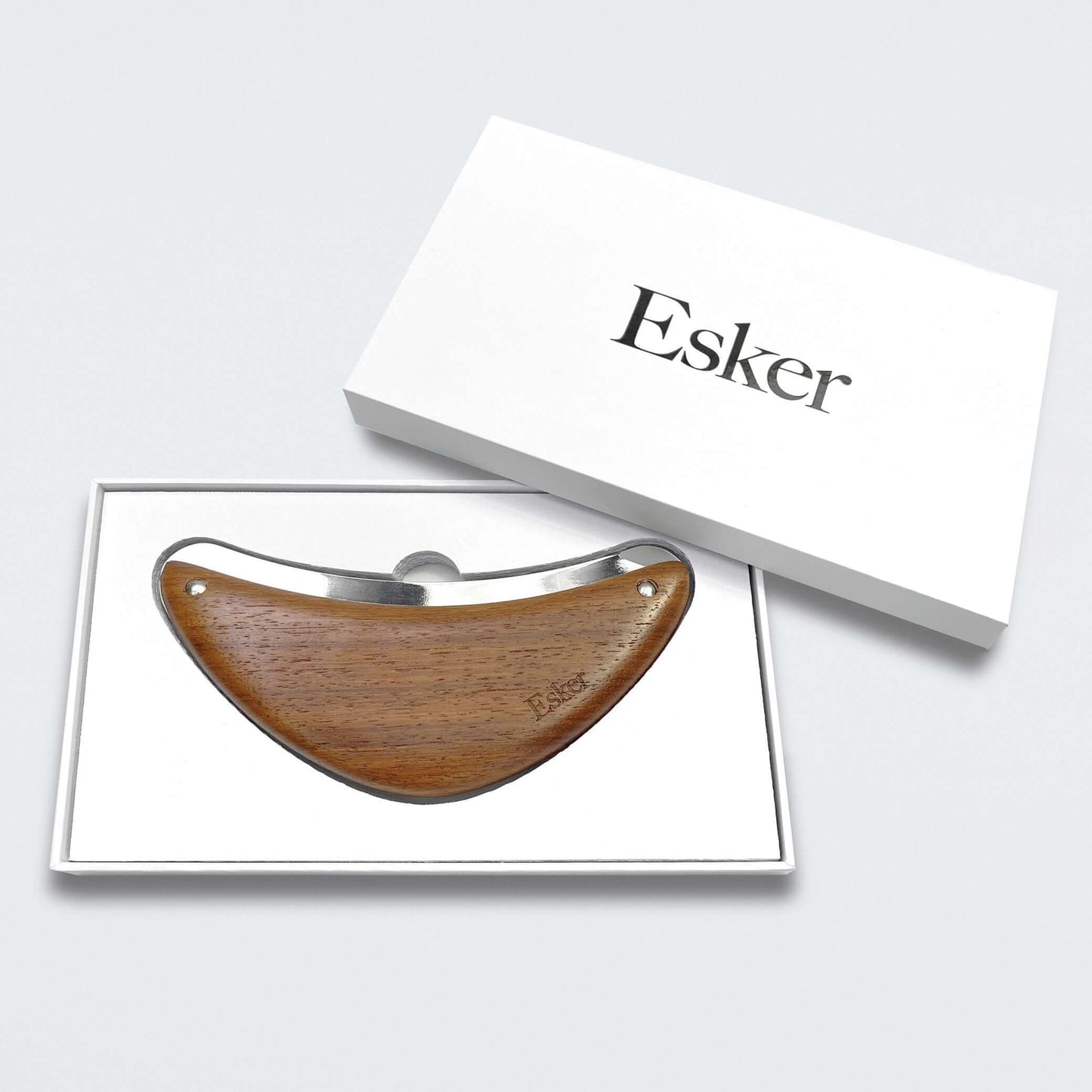 Esker wood exfoliator tool in an open gift box with a branded outer sleeve