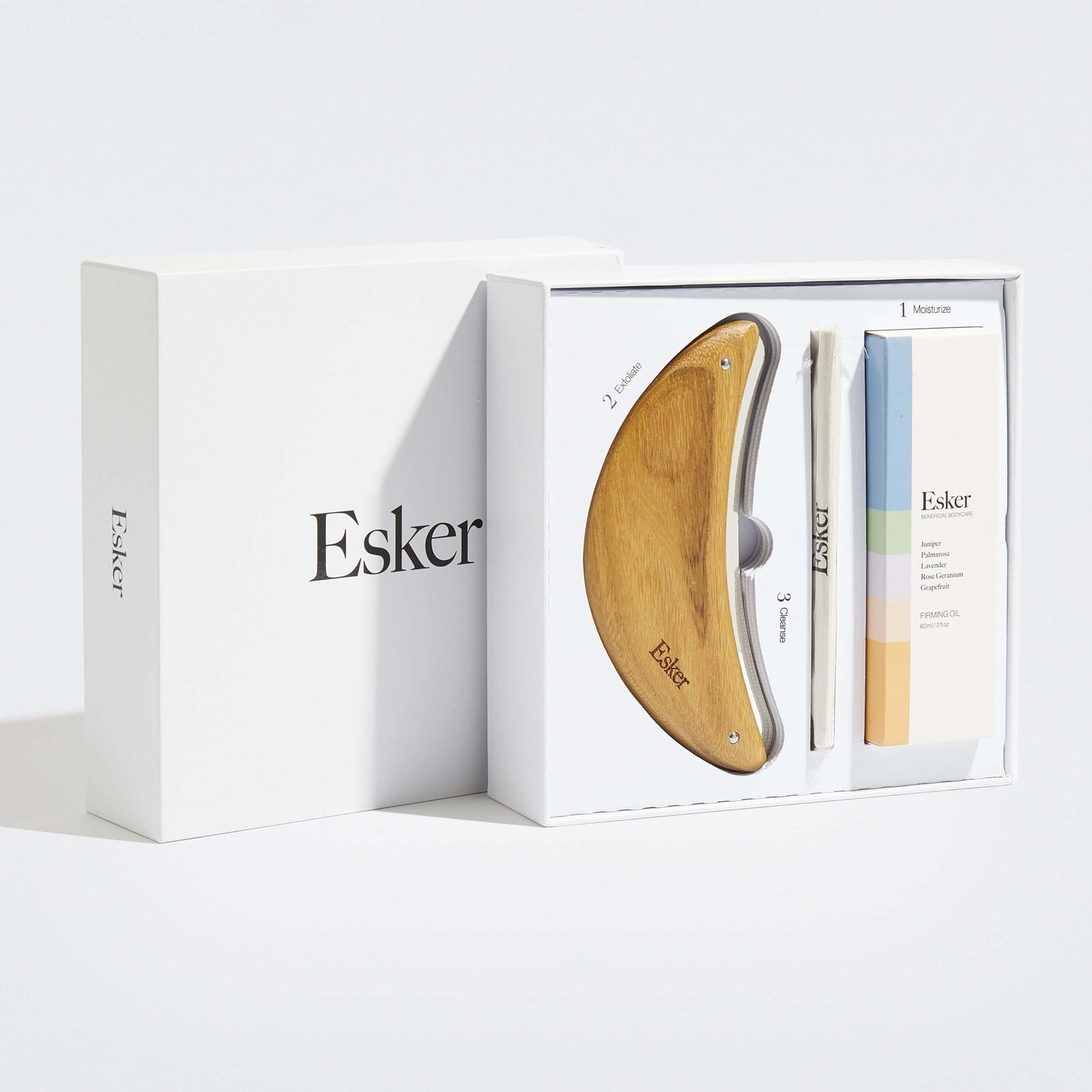 Exfoliation tool set in white packaging with wooden blade and oil bottles