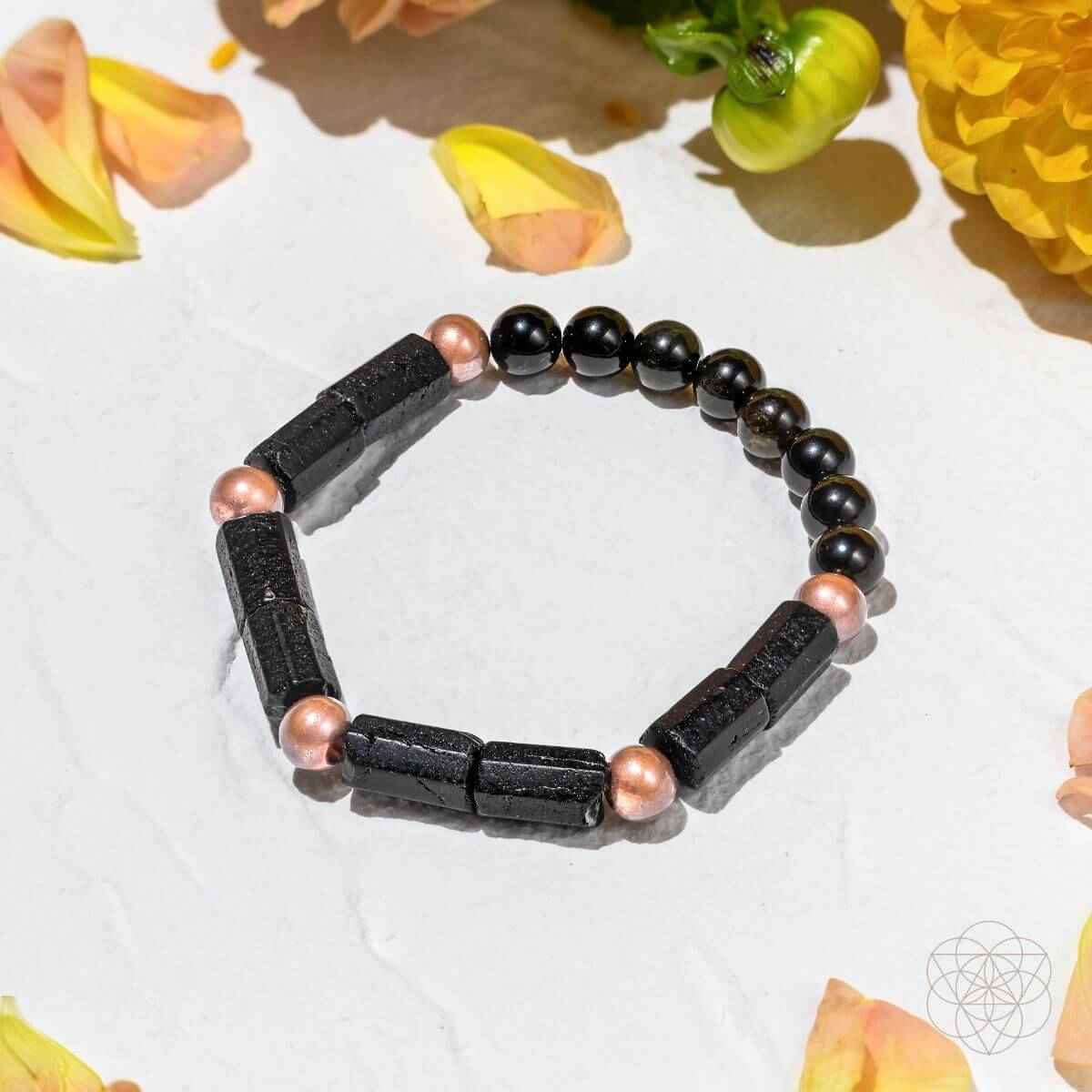Copper-tone and black bead bracelet with rectangular dark spacer beads