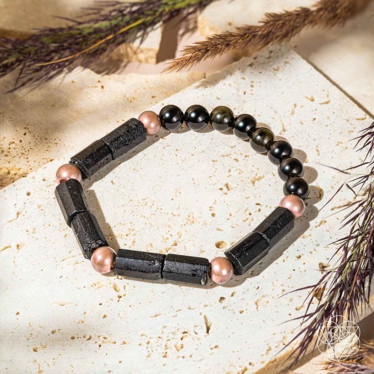 Copper-tone and black beaded bracelet with rectangular dark spacer bars