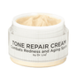 Face cream jar with open lid and pale cream inside, white ribbed label