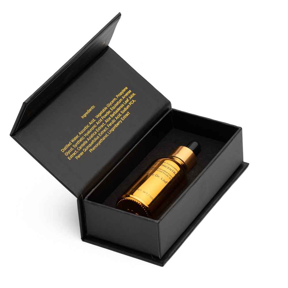 Vitamin C serum bottle inside open black gift box with gold cap