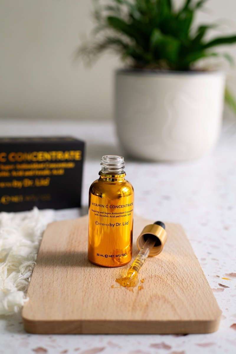 Amber Vitamin C serum bottle with glass dropper bottle nearby