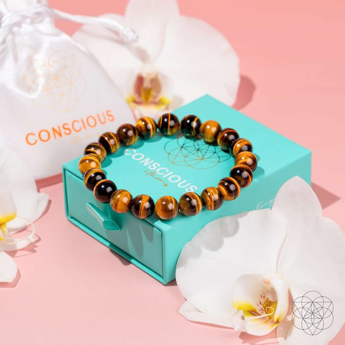 Tiger's eye bead bracelet on a box, showing round striped amber and dark beads.