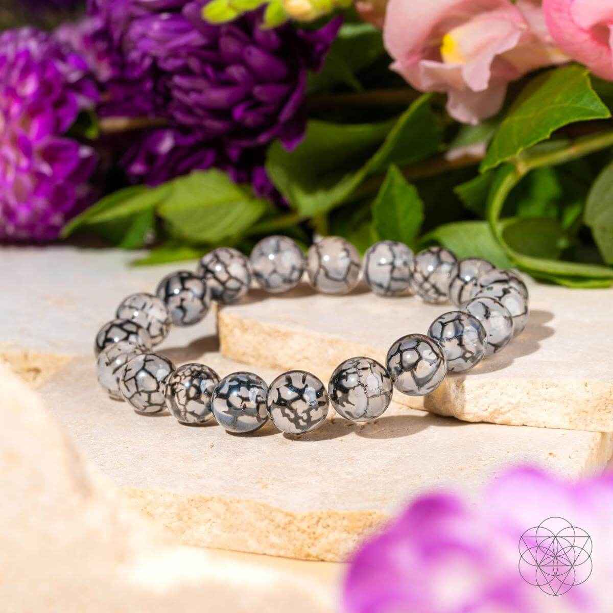 River agate stretch bracelet with gray-and-black marbled beads, round stone pattern