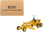 Yellow CAT motor grader diecast model with seated operator under canopy, 3-axle wheels